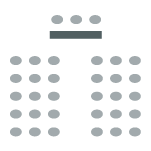 Two rows of chairs with a center aisle facing the front of the room where there is a table and chairs facing the room.