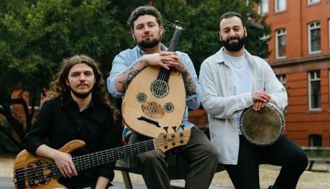 3 band members, one with an oud