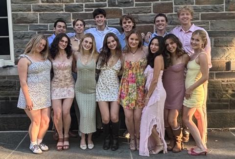 Co-ed group of college students in front of stone building
