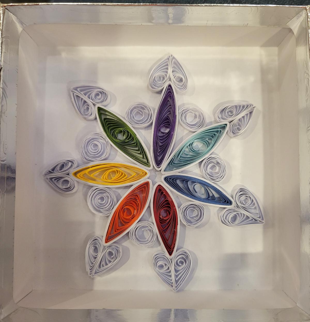 Colorful snowflake design, made with rolled paper. 