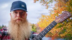 man with beard, cap, guitar